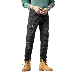 Slim fit black jeans for men with colorful paint splatters and distressed ripped details