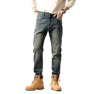 Classic men's vintage washed denim jeans in slim fit cut with retro distressed details
