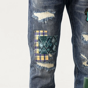 Deep blue distressed denim pants with patchwork embroidery and retro street style detail