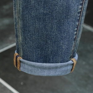 Men's slim straight blue jeans featuring stylish colorful selvedge and cuffed leg hem detail