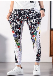 Detail view of men's slim-fit graffiti print jeans with rolled cuffs and urban style