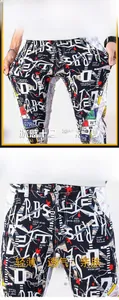 Detail of men's slim fit graffiti print jeans with elastic drawstring waist and street style