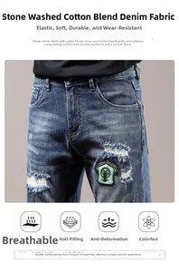 Detail of distressed blue jeans featuring stylish patches, embroidery and whisker wash