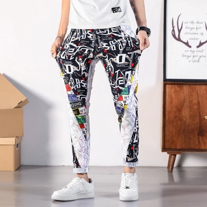 Men's slim fit jogger pants featuring vintage newspaper and graffiti print in black and white