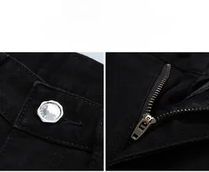 Détail du bouton argenté et de la fermeture éclair YKK sur un jean noir pour homme
