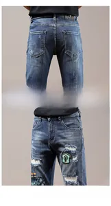 Detail of dark blue slim fit ripped jeans featuring vintage patches and shield badge