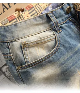 Close-up of vintage washed blue jeans with metal buttons and plaid pattern inner waist