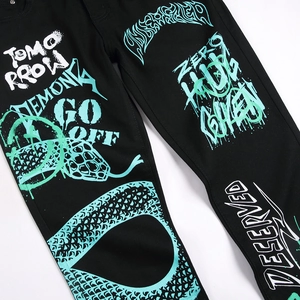 Slim fit black stretch jeans featuring vibrant green street graffiti and snake patterns