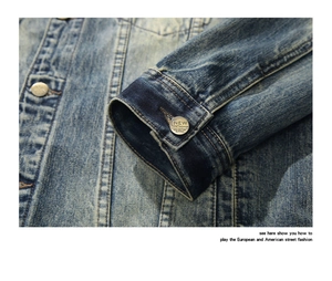 Detailed close-up of retro washed blue denim jacket with vintage silver metal buttons
