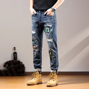 Men's slim fit distressed blue jeans with patchwork details and embroidery style