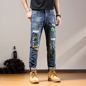 Men's slim fit distressed jeans with vintage patches and embroidery details