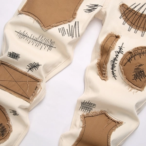 Slim fit men's street casual pants with beige patchwork and artistic embroidery details
