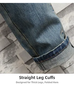 Detail of classic blue denim straight leg jeans showing washed texture and hem stitching
