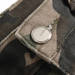 Close-up of durable camo cotton cargo pants showing quality metal button and twill texture