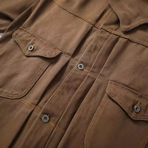 Vintage brown canvas workwear jacket with multiple pockets and durable metal buttons