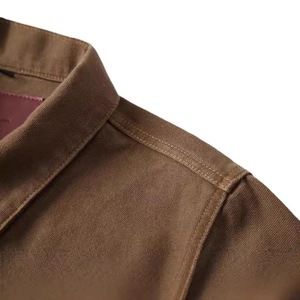 Rugged brown canvas worker jacket showing collar detail and reinforced stitching quality