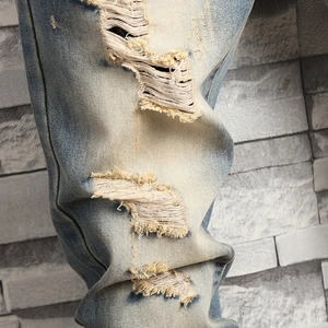 Men's retro light blue washed jeans with heavy distressed ripped knees and straight fit
