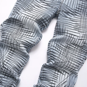 Slim fit light blue flared jeans for men with black street art graffiti print