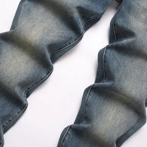 Slim fit men's vintage denim jeans in dark blue with natural fading and washed textures