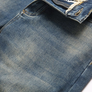 Slim fit vintage blue denim jeans with washed texture and reinforced double stitching