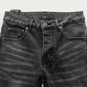Men's American vintage distressed black straight denim pants with metal button detail