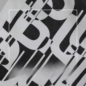Detailed macro view of the white denim fabric with black abstract letter print texture