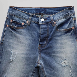 Washed blue stretch flare jeans with distressed cat-whisker details and embroidery