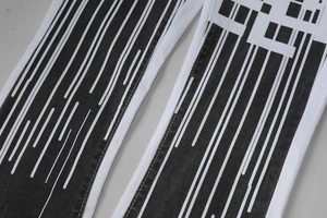 Detailed macro view of white jeans featuring unique black vertical stripe print texture