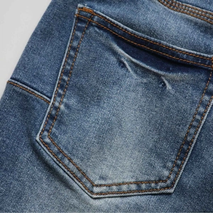 Close-up of contrast stitching on rear pocket of blue stretch flare denim jeans