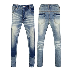 Detail shot of light wash distressed jeans featuring contrast patchwork and honeycombs