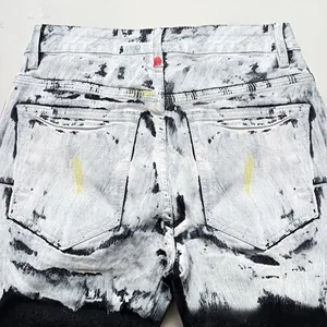 Close-up of black and white acid wash marble texture on denim jeans back pockets