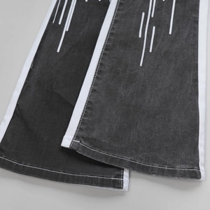 Men's washed black denim jeans featuring white side stripes and vertical print detail