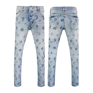 Detail of light blue slim fit jeans with dark blue all-over star and floral pattern