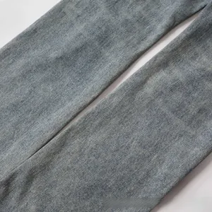Detailed macro shot of washed blue denim fabric texture and high-quality twill stitching