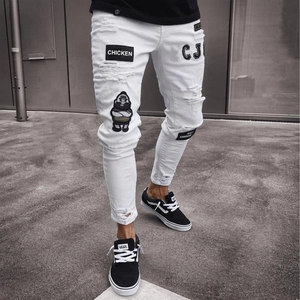 Men's white slim fit ripped denim jeans with embroidered badges and distressed details