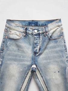Men's light blue flared jeans with paint splatter and vintage washed finish