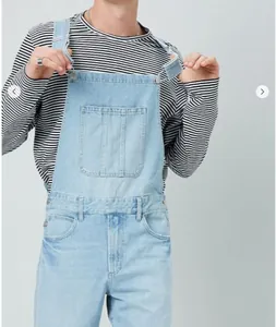 Detailed close-up of men's light blue denim overalls with classic multi-pocket and metal buckles