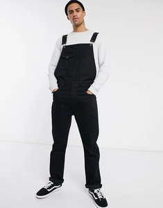 Detail view of men's black denim overalls with adjustable metal buckles and chest pockets