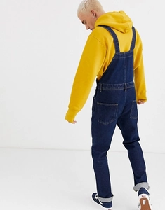 Detail showing the back view of classic denim overalls with large functional pockets