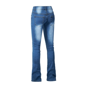 Detail of high-waist flared jeans featuring washed denim texture and back pockets