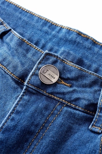Detail of waist closure on blue denim jeans featuring a metal button and yellow topstitching