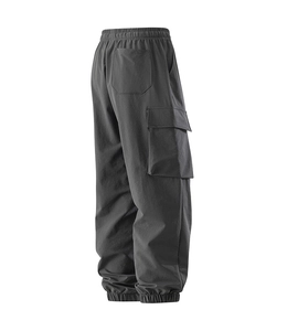 Detail of dark grey cargo pants featuring elastic waist, large flap pockets, and cuffed ankles