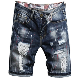 Men's distressed denim shorts in dark blue with paint splatters and ripped details