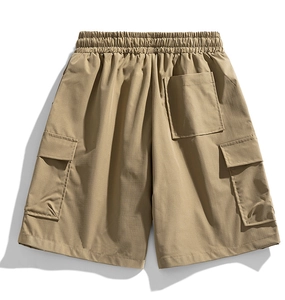 Detail of khaki cargo shorts showing elastic waistband and large side utility pockets