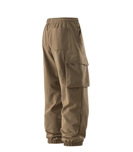 Detail view of khaki cargo pants featuring elastic waist and large side flap pockets