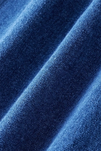 Macro shot of high-quality indigo denim fabric texture with twill weave details