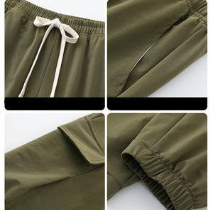 Detail view of olive cargo pants featuring drawstring waist, flap pockets, and ribbed cuffs