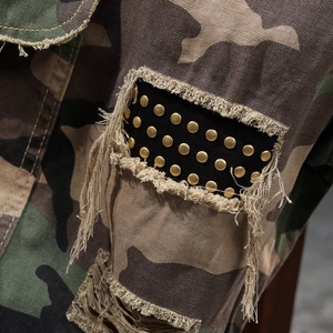 Men's loose camo cargo shorts with decorative gold studs and distressed fringe hem detail