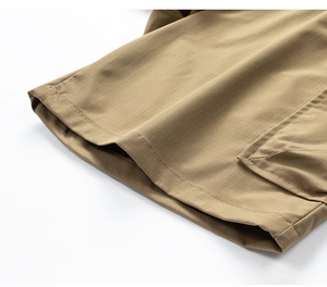 Detailed macro view of khaki ripstop fabric and cargo pocket stitching on men shorts