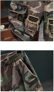 Detailed macro view of camo cargo shorts with side pockets and metal rivet patches